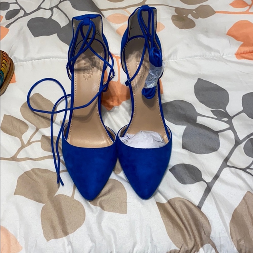 Blue laced up covered toe heels.